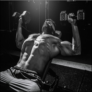 Really Strong Man Doing Incline Dumbbell Press